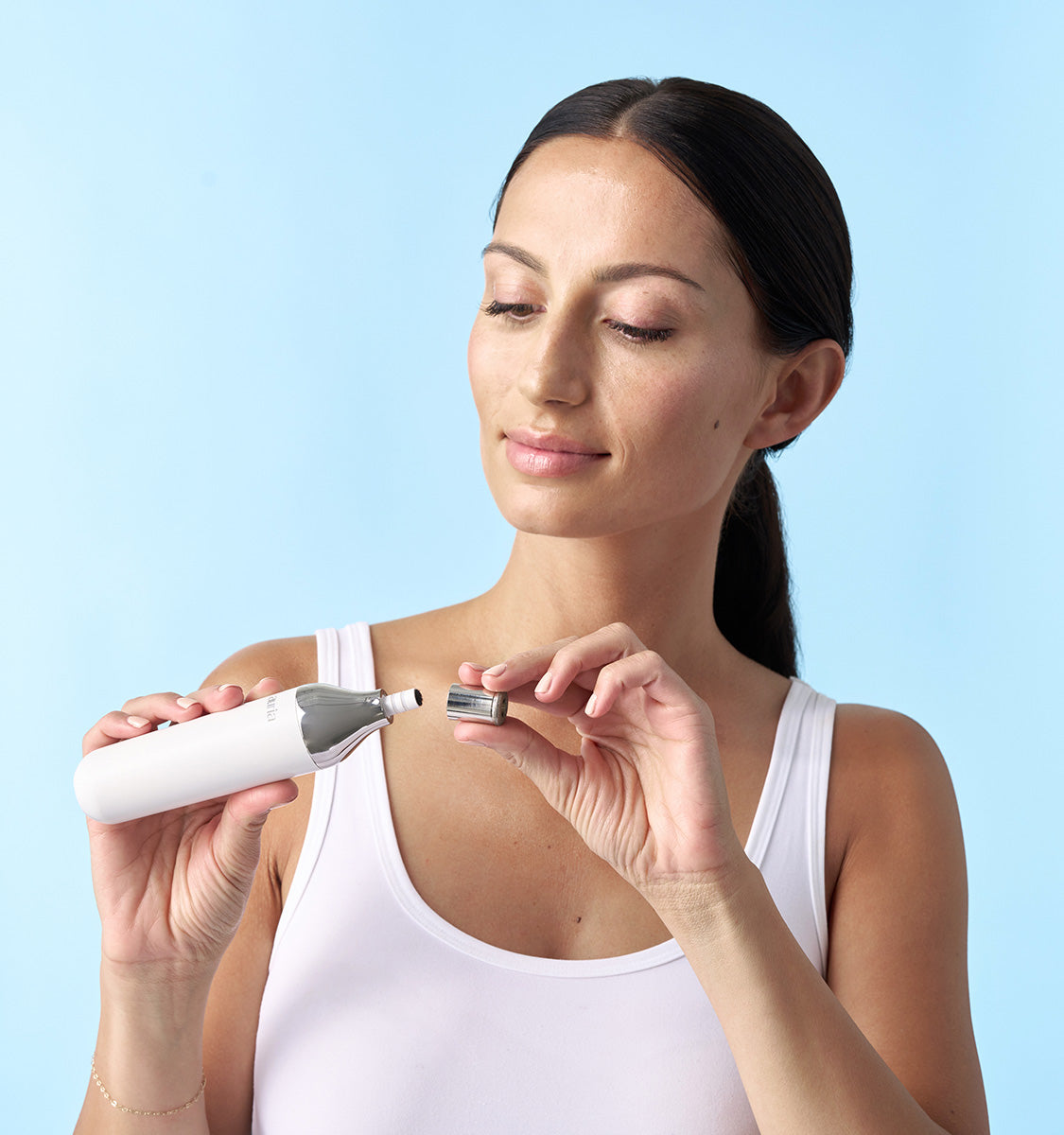 woman putting on Auria Microdermabrasion Fine Diamond Tip