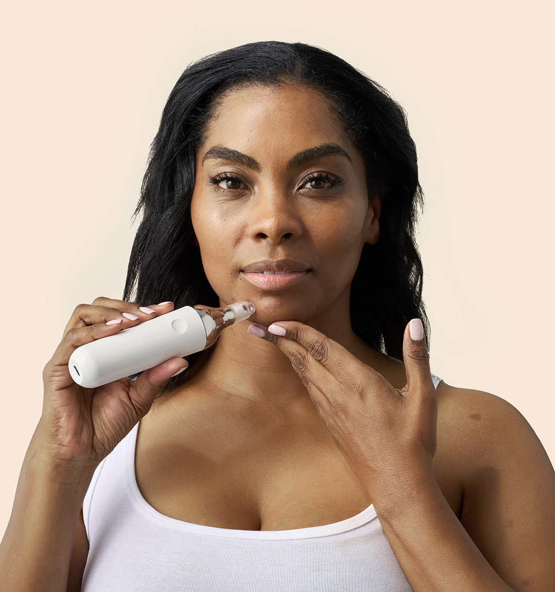 woman using Auria Microdermabrasion Pore Extraction Tip